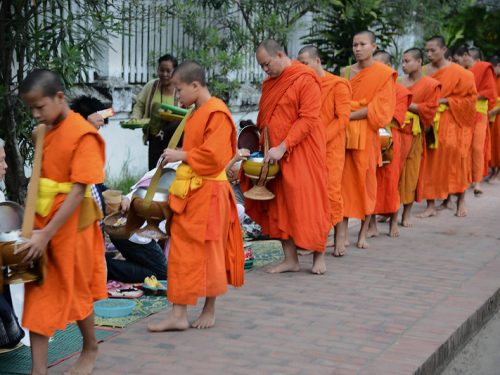 Luang Prabang morning alms giving ceremony with Buddhist monks on the street