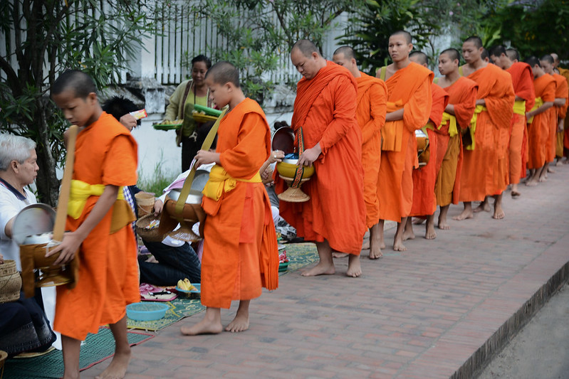 Luang Prabang morning alms giving ceremony with Buddhist monks on the street