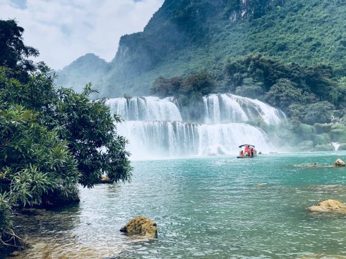 Tourists enjoying a bamboo raft on the Quay Son River during a Ban Gioc Waterfall tour