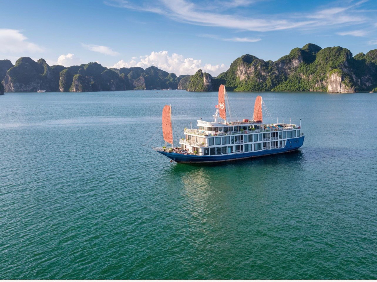 Halong Bay Luxury Cruise Verdure Lotus Grandeur sailing across Lan Ha Bay during a peaceful luxury voyage