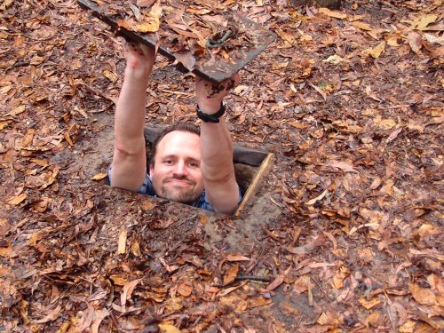 Tourists exploring Cu Chi Tunnels during the Ho Chi Minh Cu Chi Mekong Delta Tour in southern Vietnam