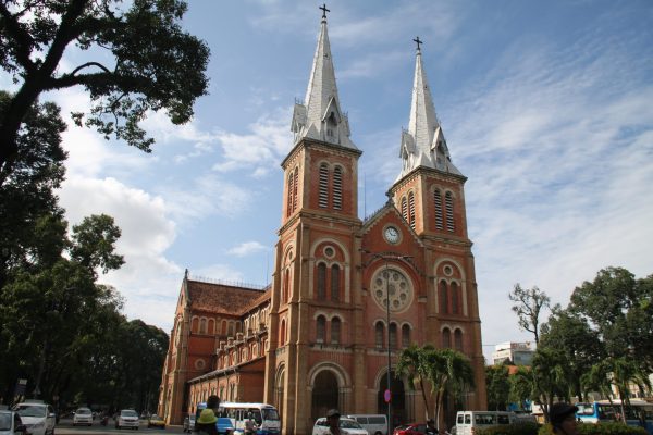 Tourists exploring the Notre Dame Cathedral during a Ho Chi Minh City half day trip