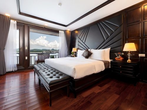 Elegant double room on La Regina Legend Cruise with premium bedding, large window, and sophisticated decor in Lan Ha Bay