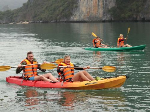 Kayaking in Halong Bay’s emerald waters during a Halong Bay Luxury Day Cruise