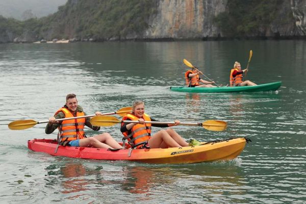 Kayaking in Halong Bay’s emerald waters during a Halong Bay Luxury Day Cruise