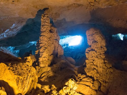 Hanoi Halong Bay day trip cruise ship with tourists exploring Sung Sot Cave and limestone islands in Ha Long Bay