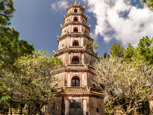Thien Mu Pagoda and Perfume River view Alt text: Sightseers visiting Thien Mu Pagoda on a Hue Imperial City Tour Full Day from Da Nang, appreciating the tranquil riverside