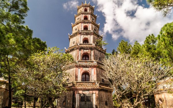 Thien Mu Pagoda and Perfume River view Alt text: Sightseers visiting Thien Mu Pagoda on a Hue Imperial City Tour Full Day from Da Nang, appreciating the tranquil riverside
