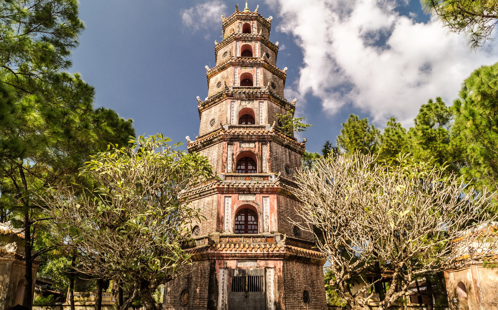 Thien Mu Pagoda and Perfume River viewAlt text: Sightseers visiting Thien Mu Pagoda on a Hue Imperial City Tour Full Day from Da Nang, appreciating the tranquil riverside