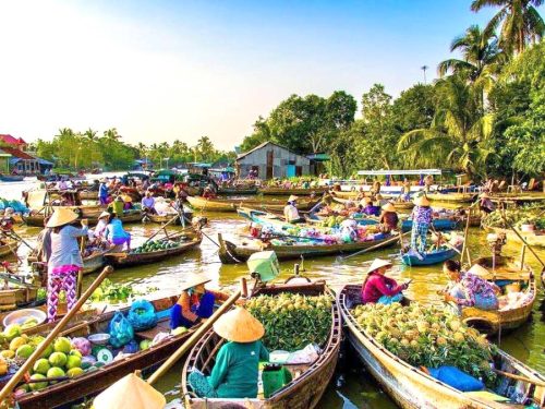 Local traders on boats selling fresh fruits at Cai Rang Floating Market in Mekong Delta Full Day Tour