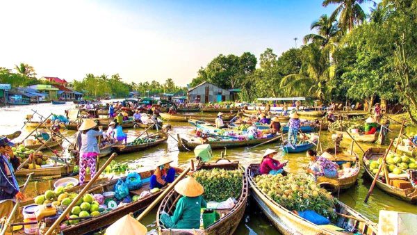 Local traders on boats selling fresh fruits at Cai Rang Floating Market in Mekong Delta Full Day Tour