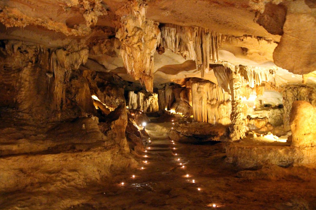 Thien Canh Son Cave, featuring impressive stalactites and stalagmites illuminated by natural light, creating a mesmerizing atmosphere for visitors to explore