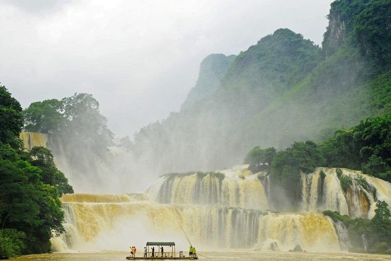 Tourists enjoying a boat ride near Ban Gioc Waterfall