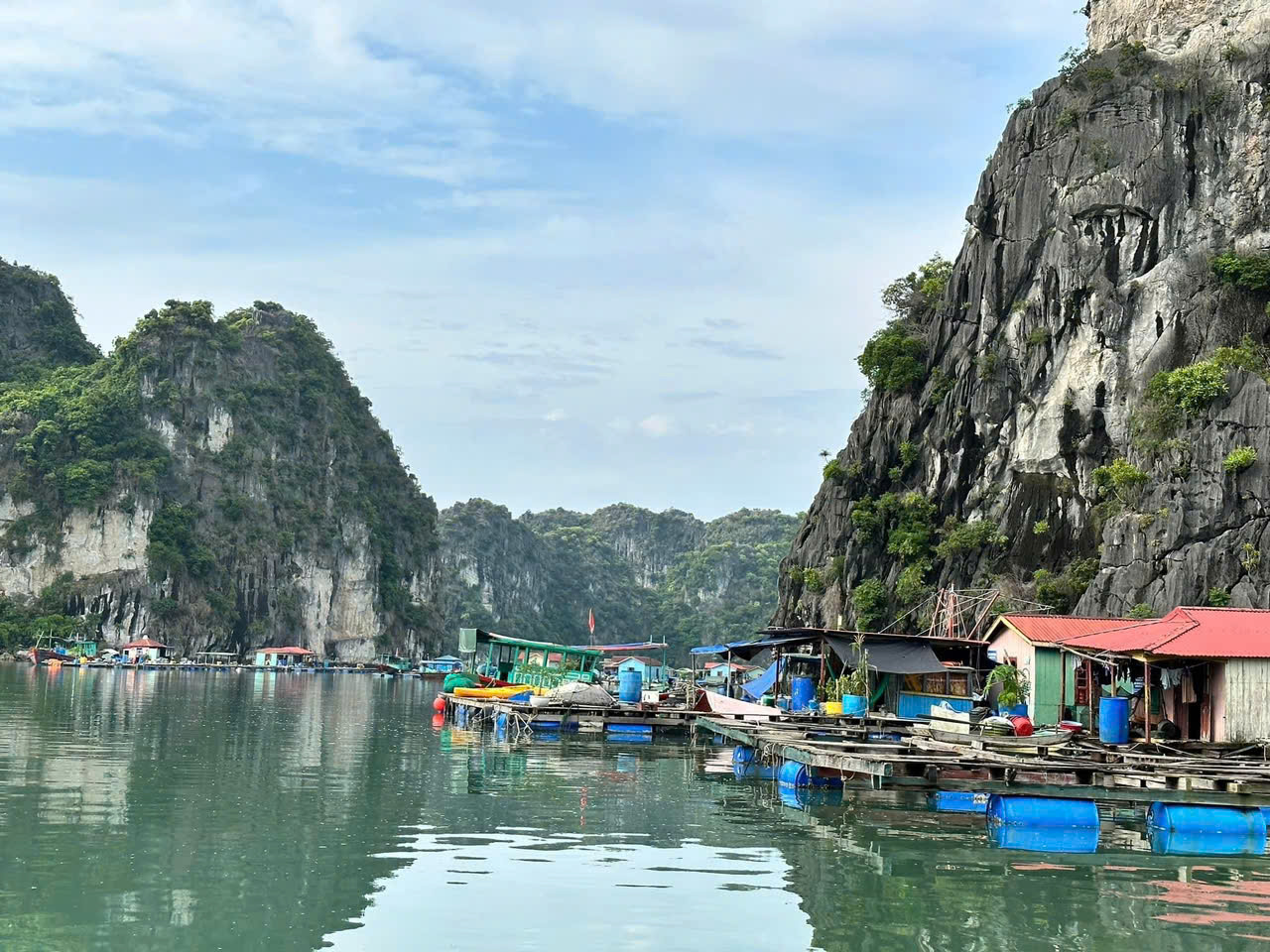 Vung Vieng Floating Village in Bai Tu Long Bay with calm emerald waters and traditional floating houses