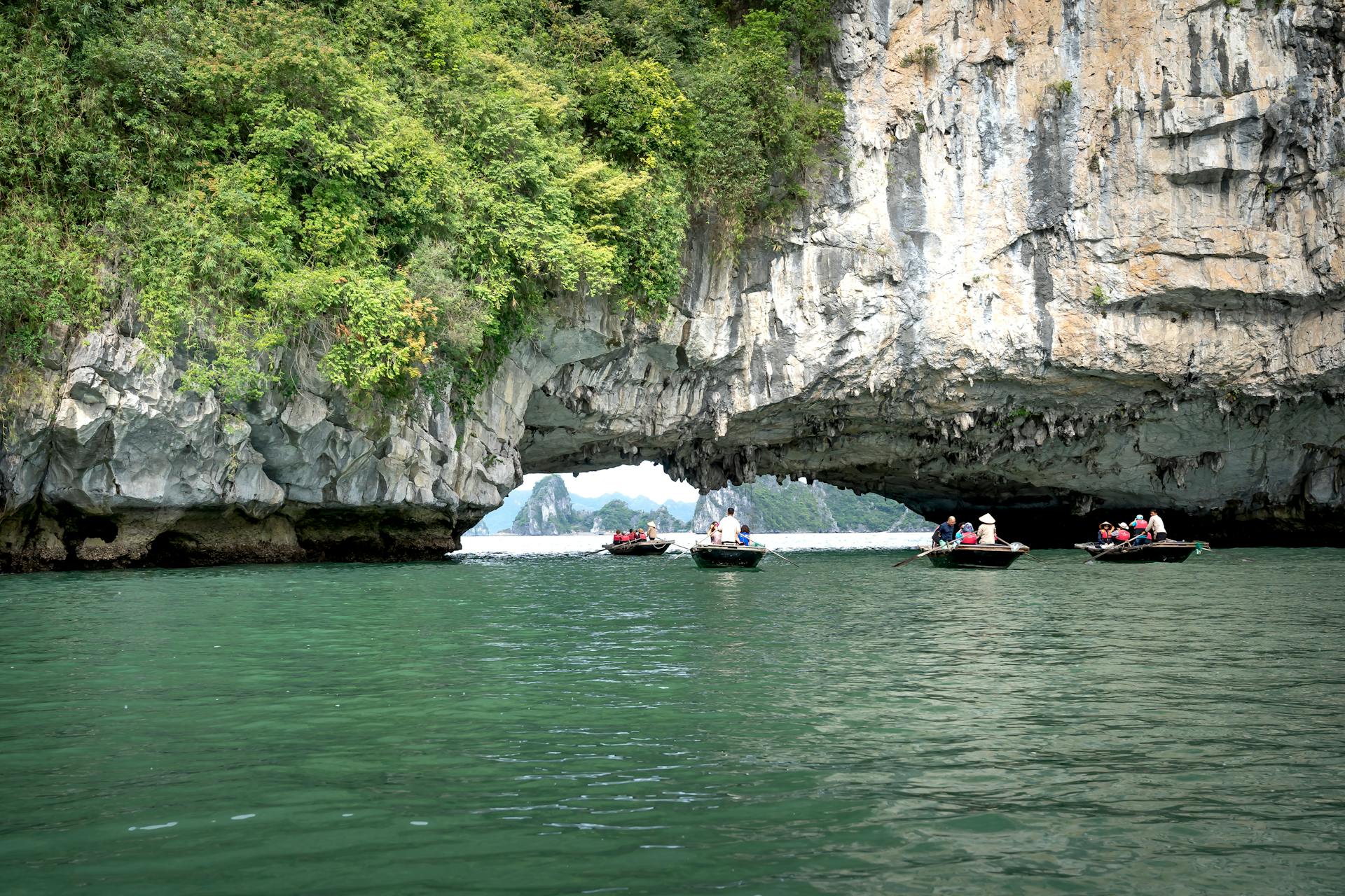 Kayaking through Luon Cave on a Halong Bay day trip, enjoying pristine waters and breathtaking natural beauty
