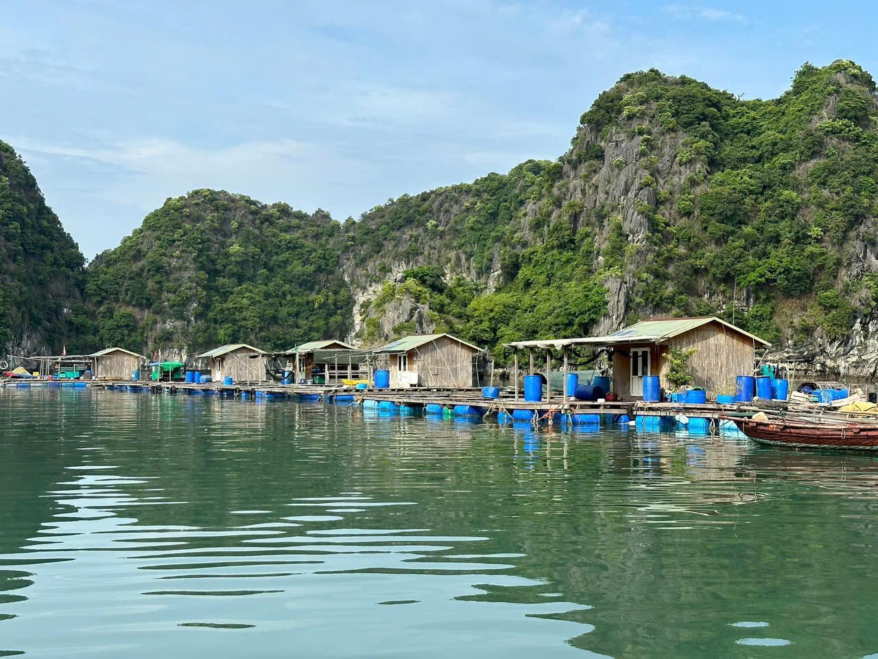 Vung Vieng fishing village on a Halong Bay day trip, featuring peaceful floating houses and a tranquil atmosphere
