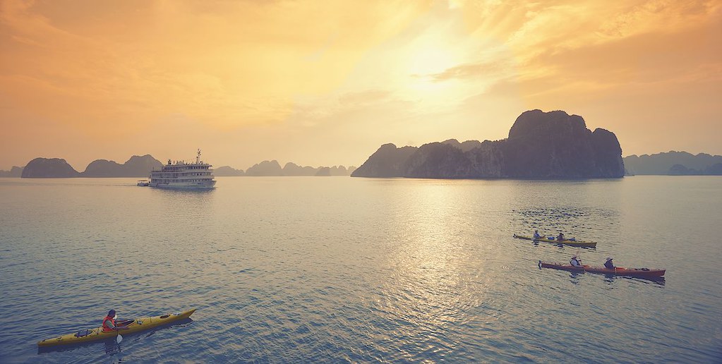 Luxury overnight cruise ship in Halong Bay at sunset during Halong Bay Tours from Hanoi