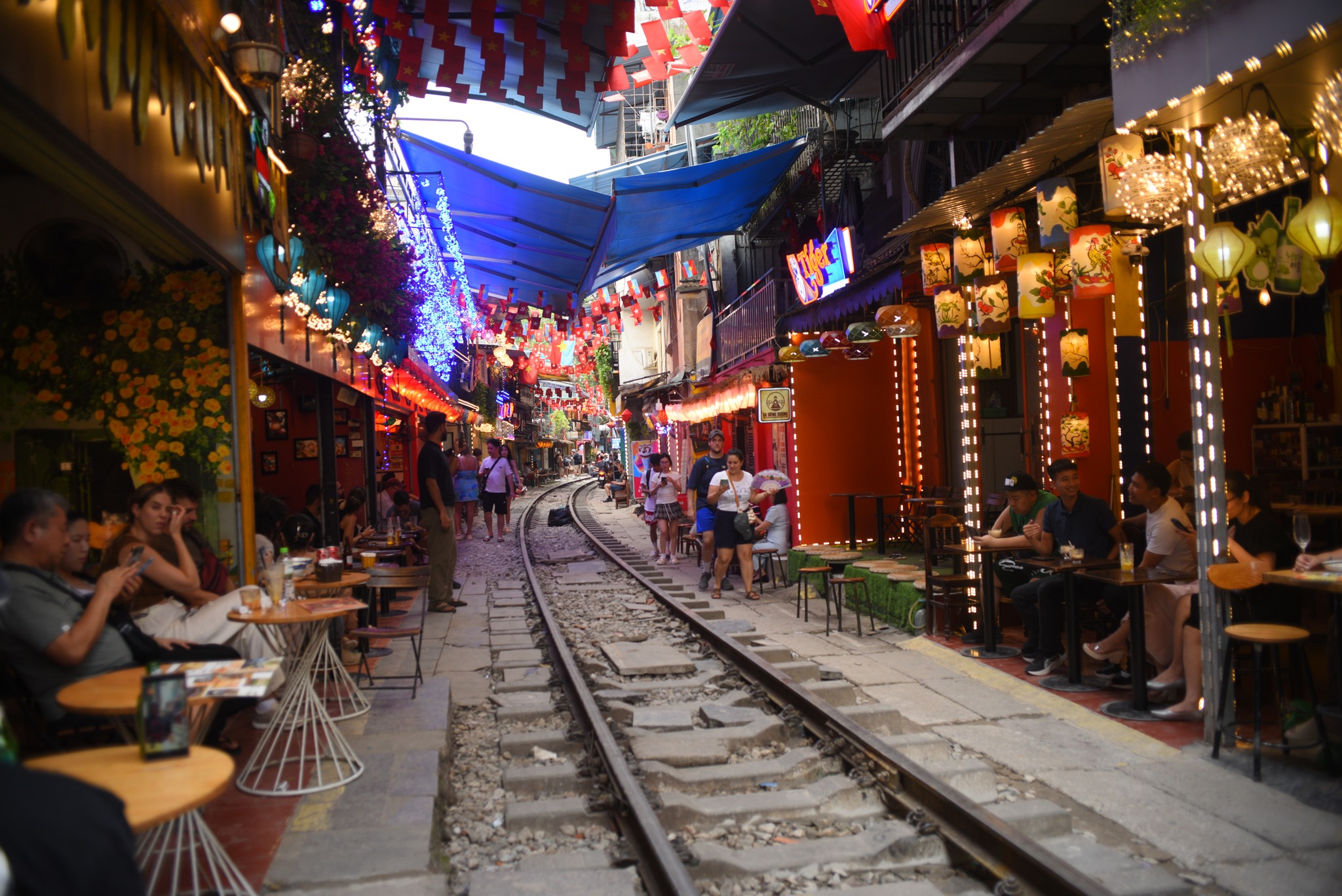 Enjoy coffee just inches from the passing trains on Hanoi Train Street