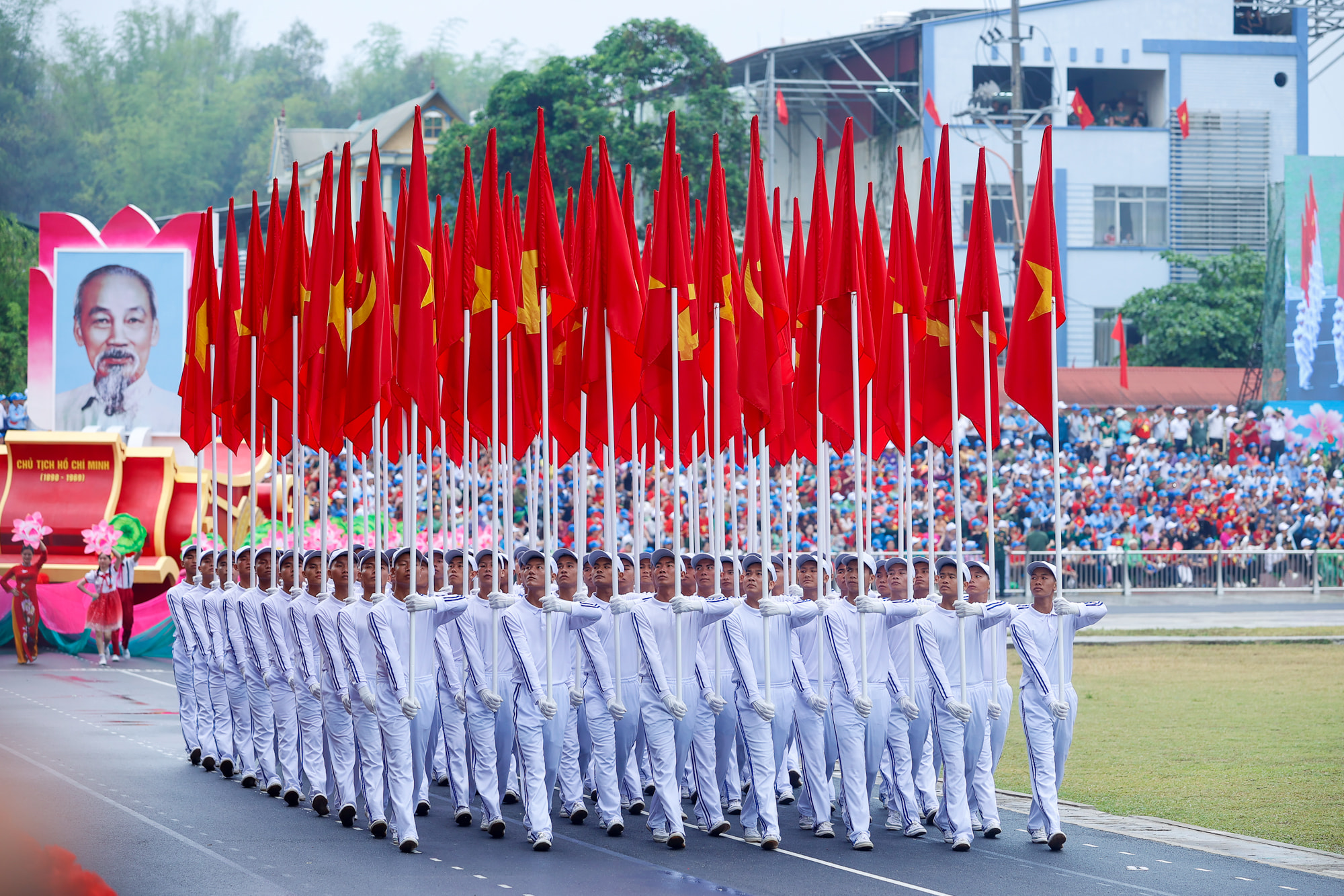 Marching soldiers with red flags demonstrating national pride during Vietnam National Day 80 Years parade