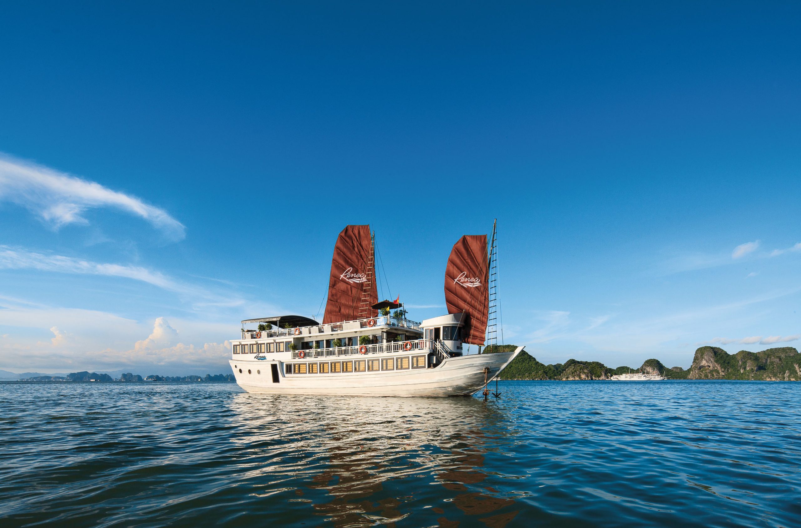 3-Day Bai Tu Long Bay Cruise – Deluxe Experience, scenic cruise sailing through Bai Tu Long Bay, Vietnam